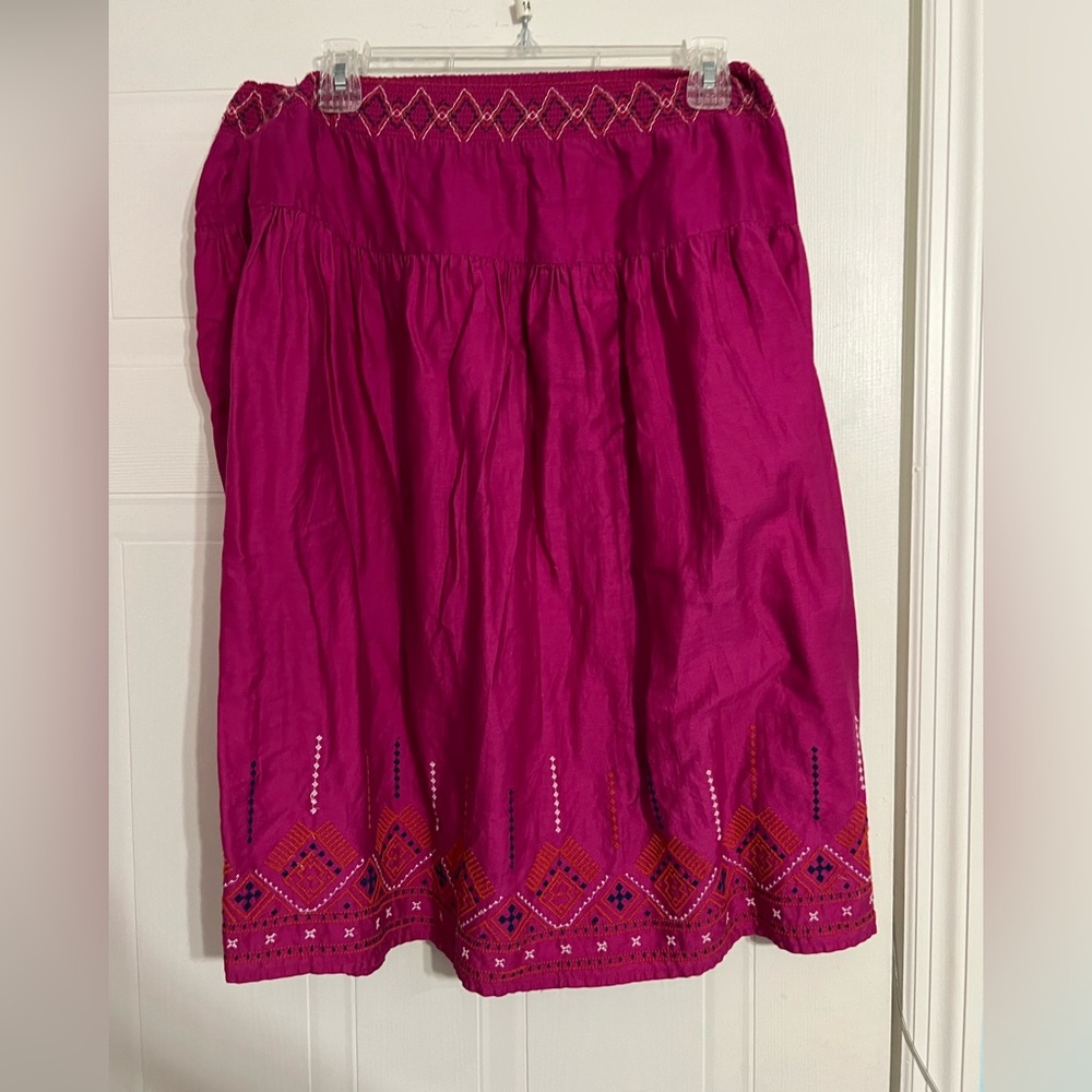 A stretchy, purple/pink, knee length skirt